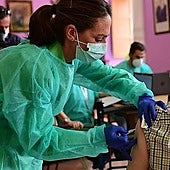 A user is vaccinated at a health centre.