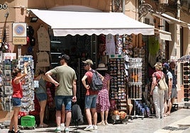 Tourists choosing a souvenir in Malaga city.