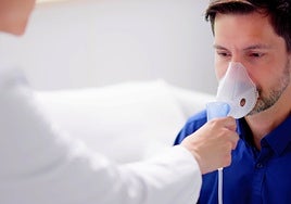 A doctor treats a man with asthma.