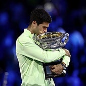 Alcaraz clutches the Australian Open trophy on Sunday.