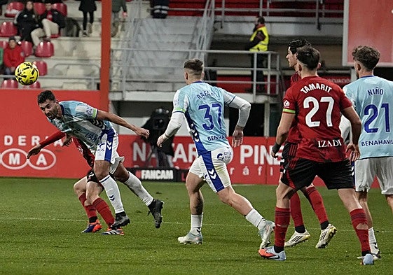 Malaga's Einar Galilea wins an aerial duel during Monday's match.