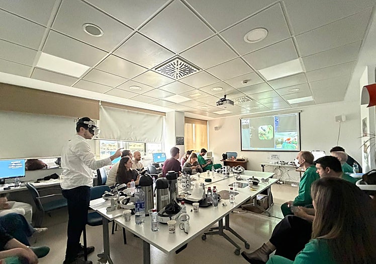 A resident doctor wearing virtual reality glasses as he attends a live endoscopy.
