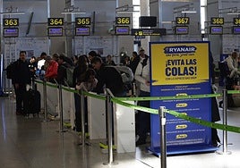 Passengers checking in their luggage at Malaga airport.
