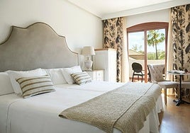 A bedrrom at La Viñuela hotel of which the headboard, bedside table and chairs are for sale.