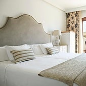 A bedrrom at La Viñuela hotel of which the headboard, bedside table and chairs are for sale.