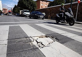 Vehicles passing through a damaged stretch in Malaga city.