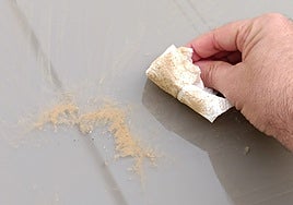 Calima accumulated on a table on a terrace in the centre of Malaga.