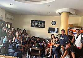 The four families trapped in Bangkok cannot return due to a connecting flight in Qatar.