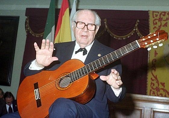 Andrés Segovia with a classical guitar.