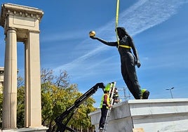 Venus is hoisted into place at the entrance to the port.