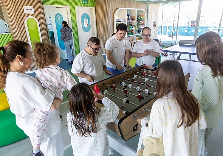 Volunteers playing foosball with some of the girls in the hospital.