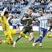 The moment Malaga's Joaquín was brought down by the keeper, who escaped a red card.