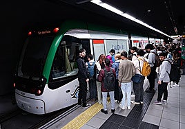Passengers waiting to get on a metro train in Malaga.