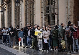 A queue of migrants outside a town hall in Valencia
