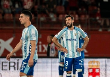 Disappointed Malaga players after conceding the late winner.