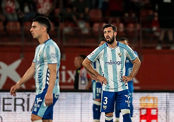 Disappointed Malaga players after conceding the late winner.