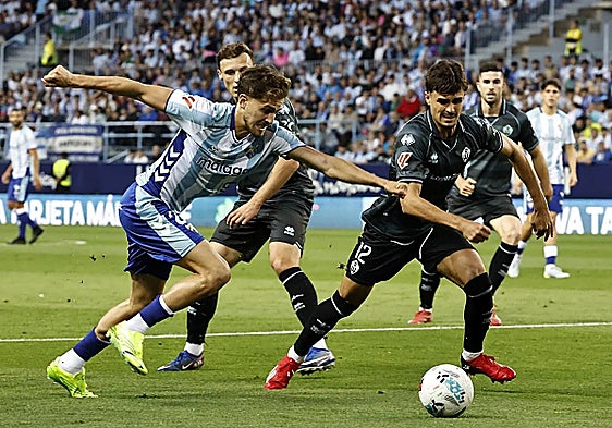 Malaga's Adrián Niño tries to force an opening on Saturday.