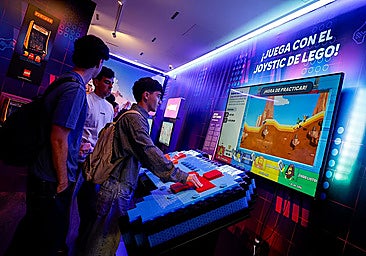 A young man playing Lego at the Danish brand's exhibit at Malaga's video game museum.