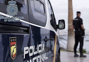 Two officers and the National Police patrol vehicle in a file photo.