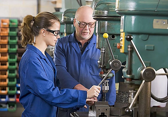 Man teaching the trade to young worker.