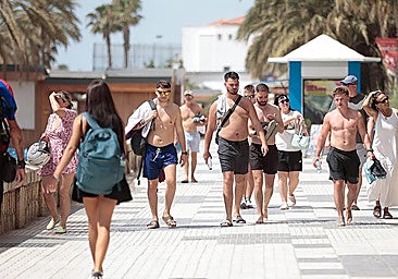 Tourists walking along the beachfront in Malaga.