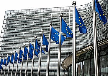 EU flags in front of the European Commission headquarters in Brussels.