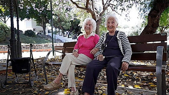 Pepa and Isidora sitting in a park near the day centre for the elderly in Malaga's Puerto de la Torre district.