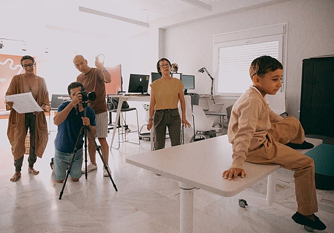 Leung Chi Wo and Sara Wong recreate an old photograph featuring a local boy.