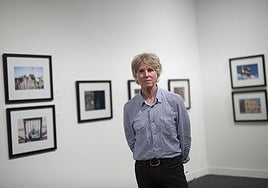 Patrick Sansone, alongside his photographs.