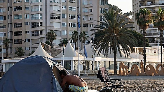 Around 20 homeless people live in tents and makeshift shelters on Malaga's La Malagueta beach