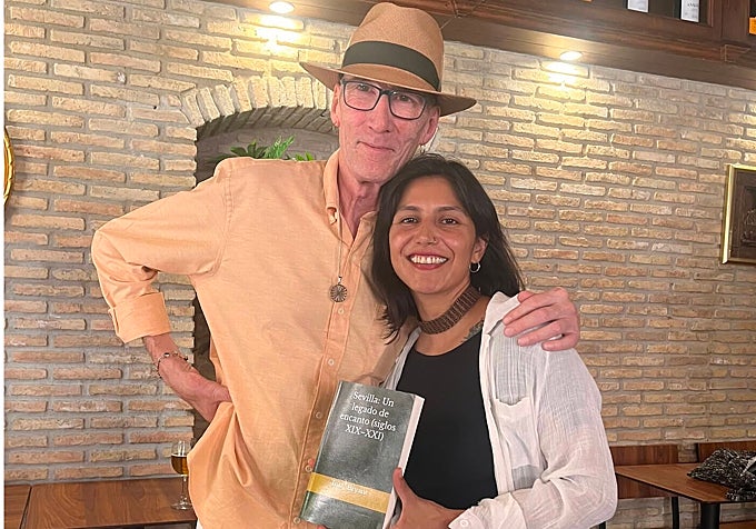 Bryant poses with an attendee following the book presentation.