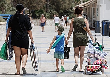 A family walking by the beach in Malaga.