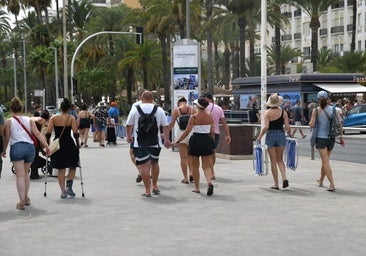 People stroll along the port of Alicante.