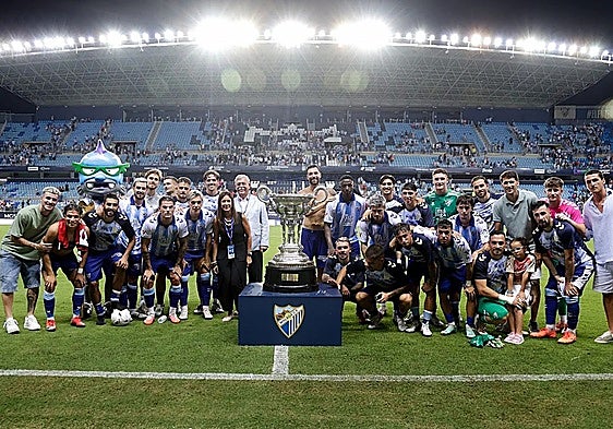 The Malaga players with the Trofeo Costa del Sol.