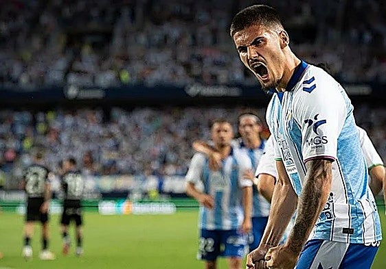 Malaga's Chupete celebrates equalising from the spot.