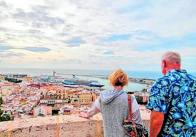 British tourists admire the city of Almería from the Alcazaba.