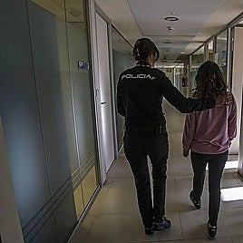 A National Police officer accompanying a woman who has just filed a gender-based violence complaint in Spain.