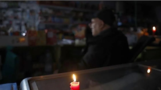 A shop in Barcelona, lit by candles following the nationwide power cut.