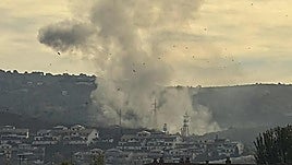 A plume of smoke rising from the munitions factory.