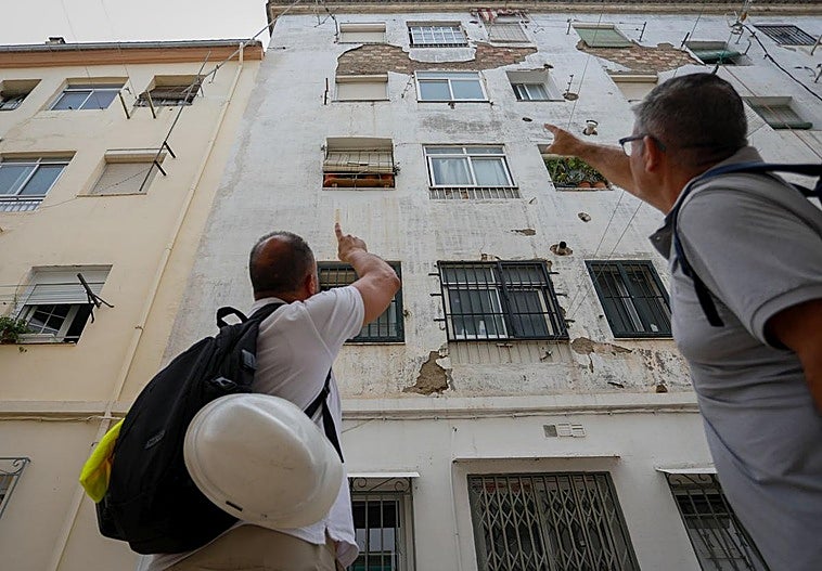 Two quantity surveyors are inspecting one of the oldest buildings in Santa Adela.