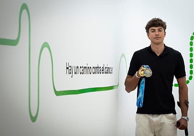 Nico shows one of his medals during a visit to the AECC this past summer.