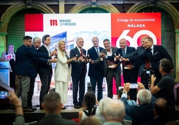 Award winners and officials pose for a photograph following the awards ceremony at the San Miguel factory.