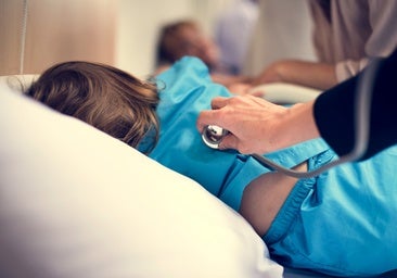 A paediatrician is treating a child.