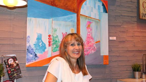 The artist at the opening of the exhition with her painting ‘Shopping'