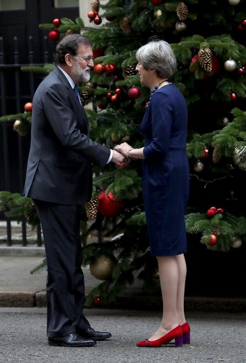 Rajoy is greeted by May at the door of Number 10.