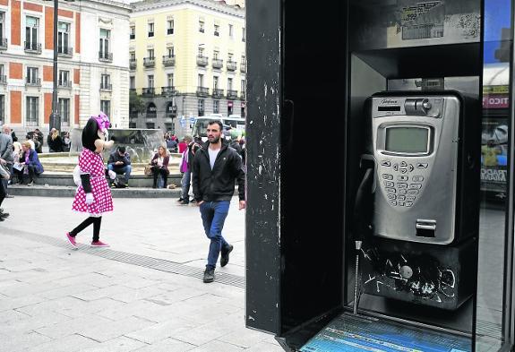 In Madrid's Puerta del Sol, one of the 18,161 public phones remaining in Spain.