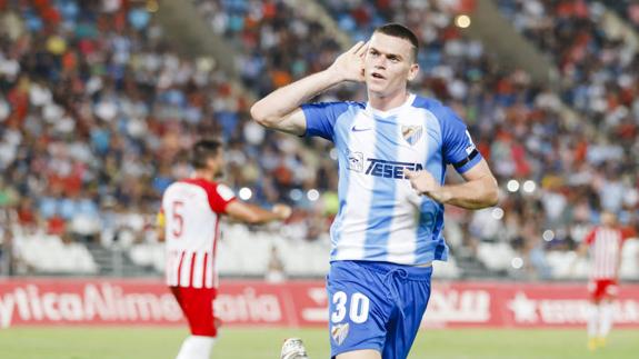 Malaga survive late scare to maintain 100 per cent record