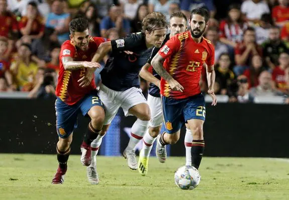 Luka Modric competes for the ball between Dani Ceballos (left) and Isco.