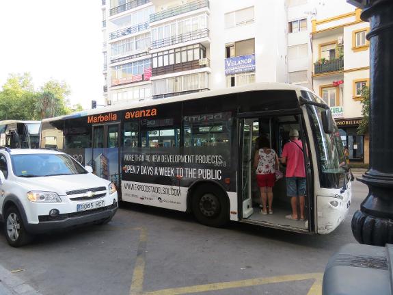Passengers get on a local bus in Marbella town centre.