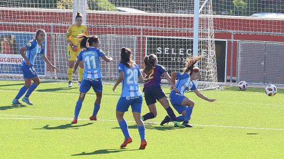 Malaga's Ruth blocks an attempt by Martens to reach Chelsea's goal.